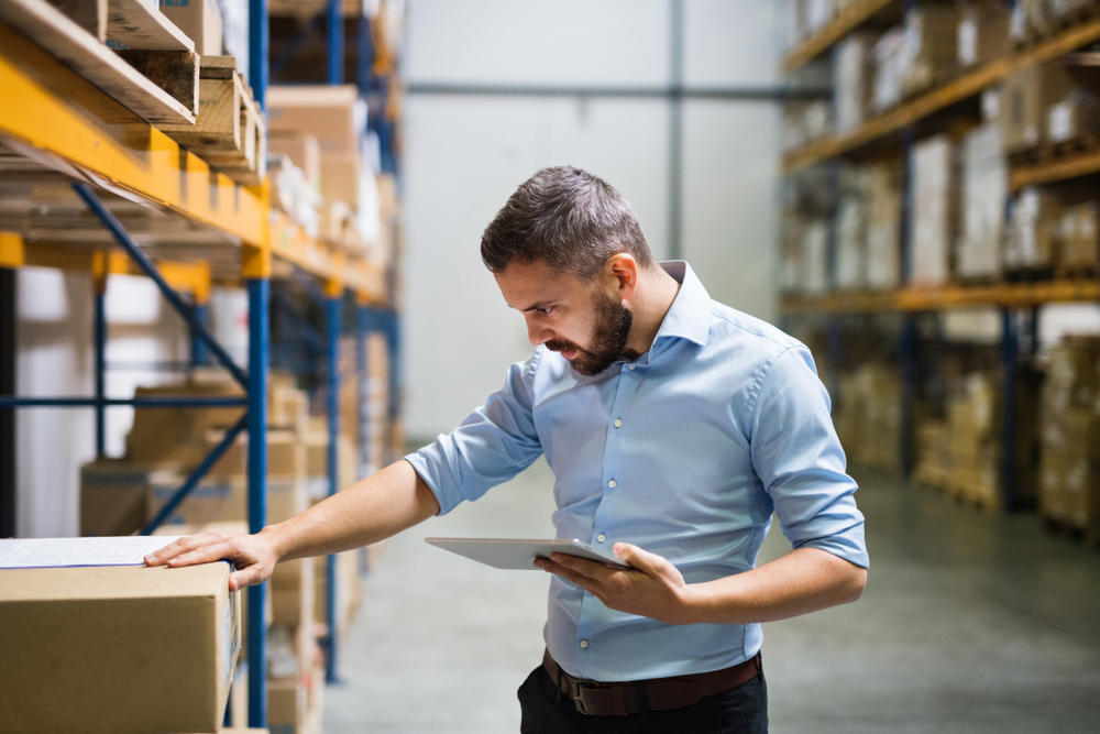 Man reviewing stock in a warehouse