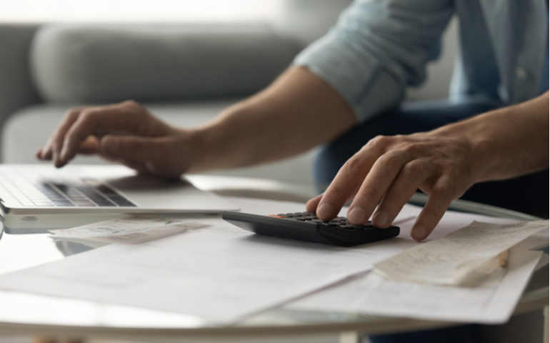 Person using a calculator to work out finances