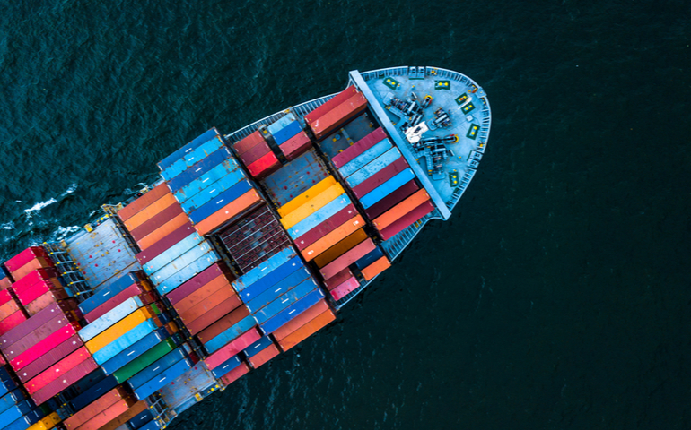 Boat with shipping containers in transit